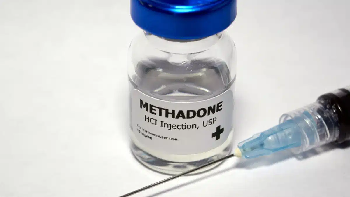 A clear bottle labeled methadone