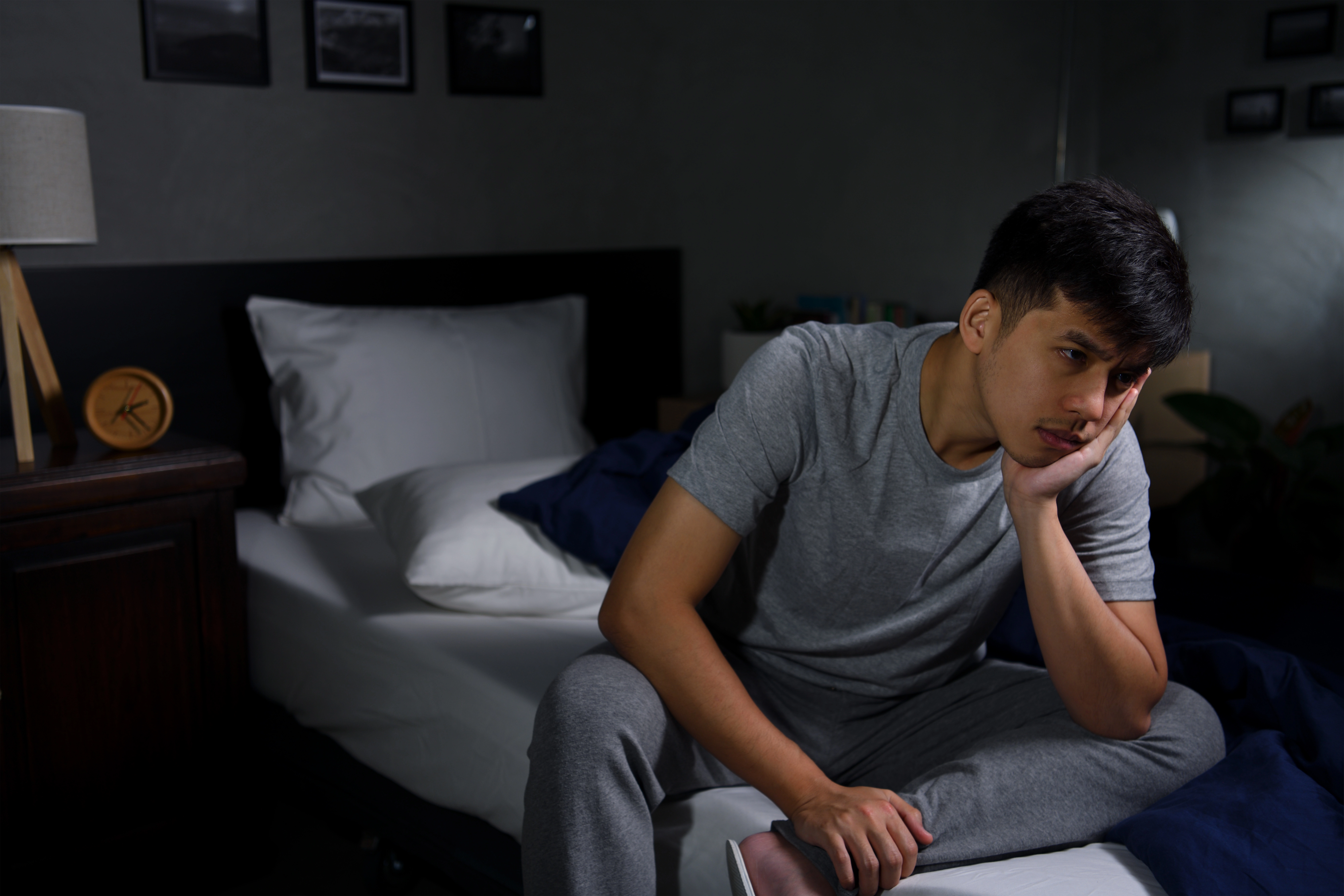 Teen boy sitting alone at night.